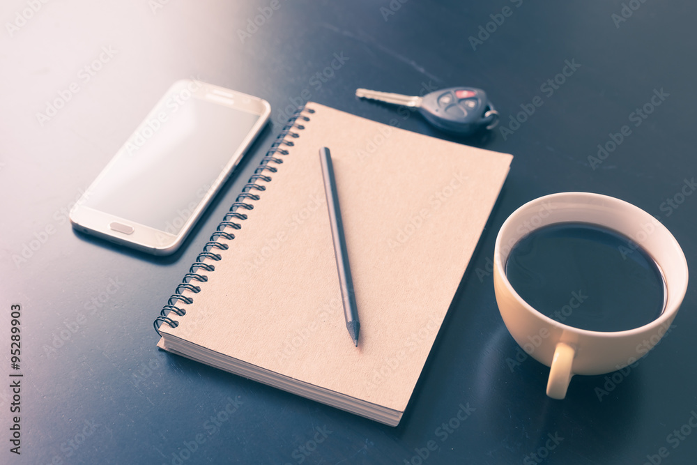 Book and coffee cup on black wooden table Book and coffee cup on black wooden table