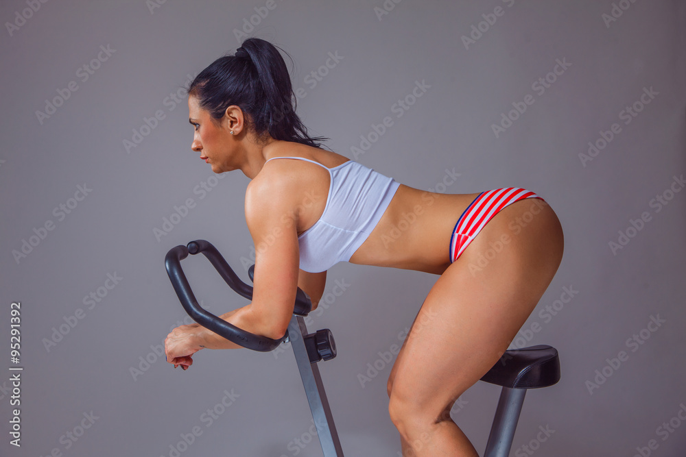 Sexy fit girl on bike.Studio shot. Stock Photo | Adobe Stock