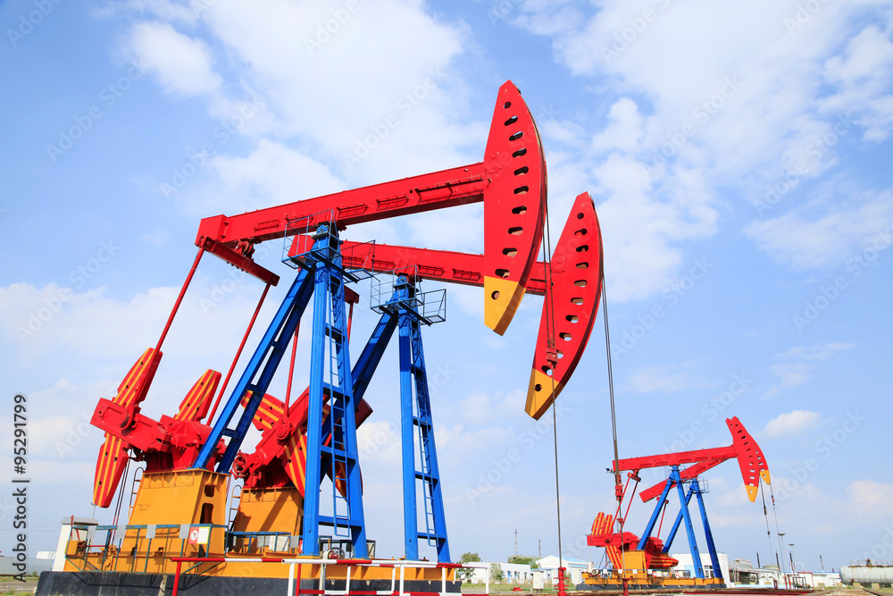 The oil pump, under the blue sky white clouds The oil pump, under the blue sky white clouds