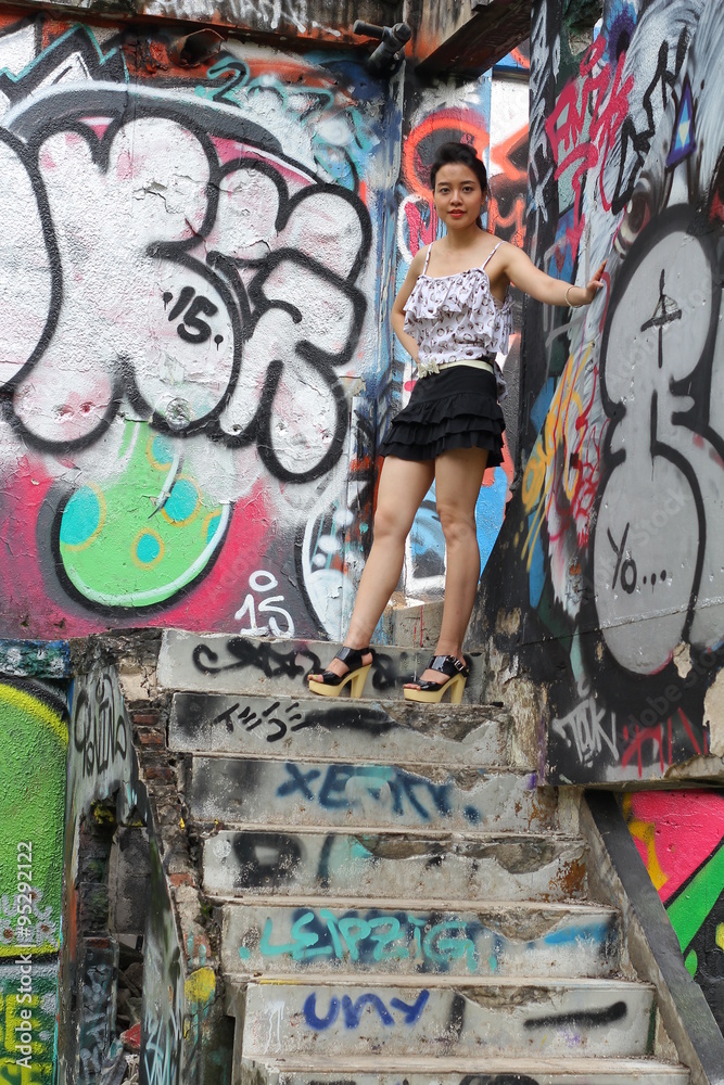 Portrait of thai adult beautiful girl relax and smile on graffiti wall
Portrait of thai adult beautiful girl relax and smile on graffiti wall