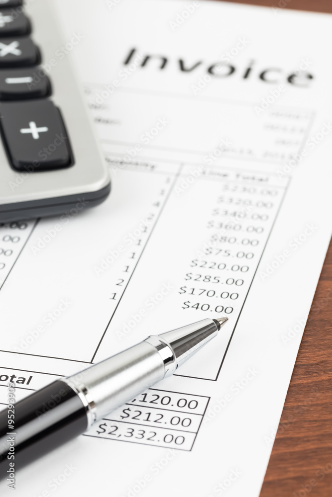 Invoice with pen and calculator; invoice is mock-up Invoice with pen and calculator; invoice is mock-up