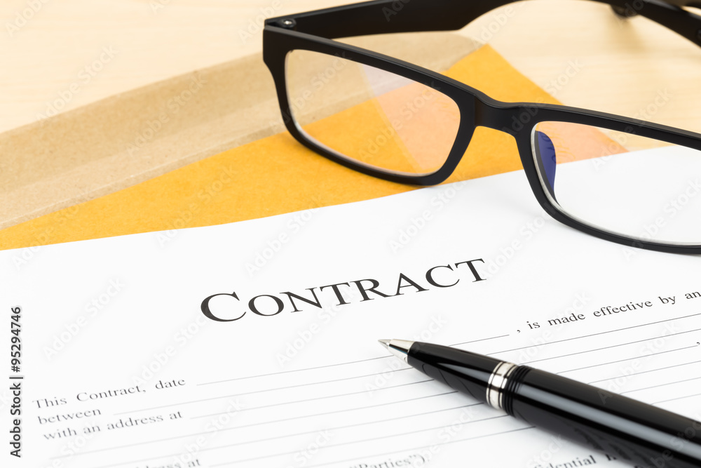 Business contract document with pen and glasses on envelope Business contract document with pen and glasses on envelope