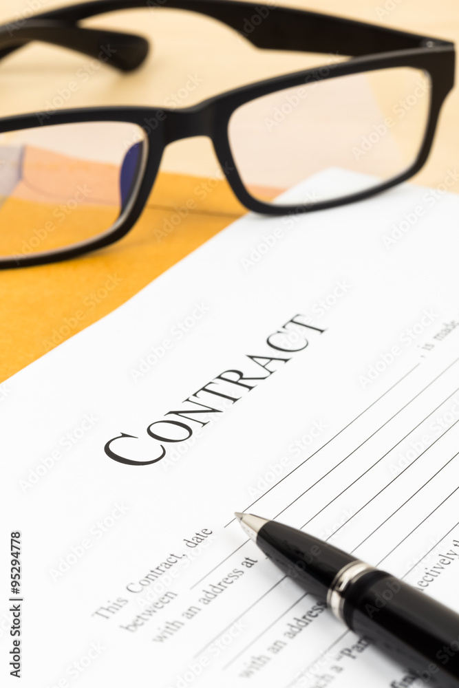 Business contract document with pen and glasses on envelope Business contract document with pen and glasses on envelope