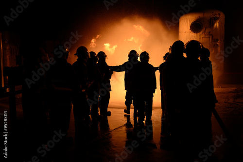 Firefighters training fighter at night.