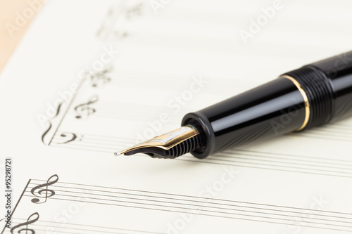Blank music score on cream color paper with pen
