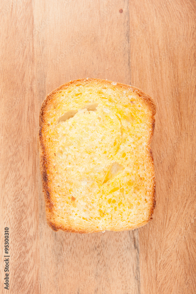 toasted bread with honey on wood table still life