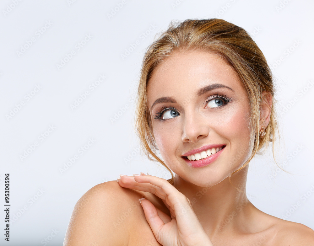 Young woman touching her face isolated on white background Young woman touching her face isolated on white background