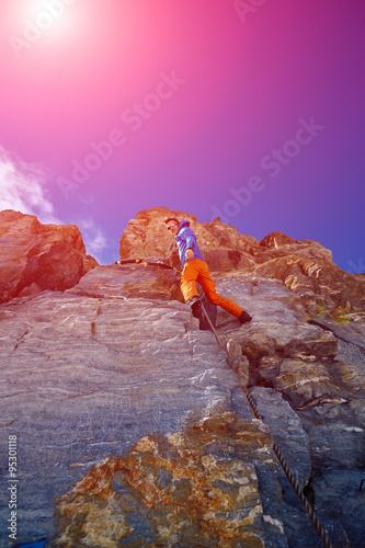 climber climbing up a cliff