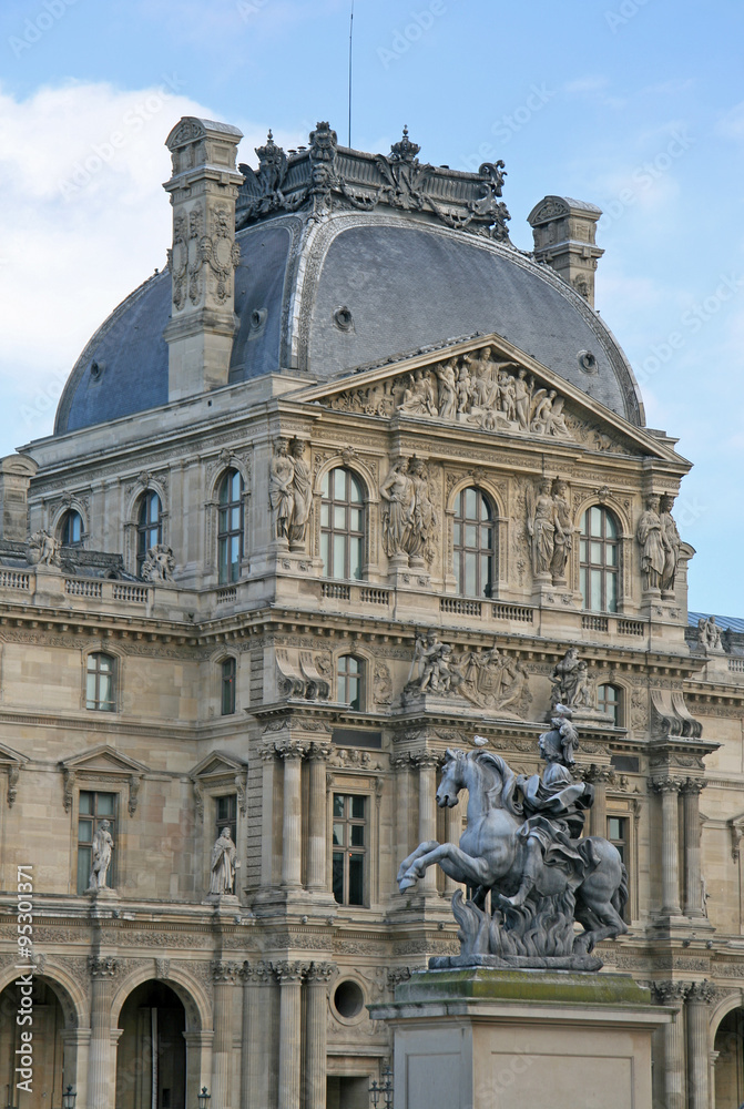 PARIS, FRANCE - NOVEMBER 27, 2009:  Fragment of one of facades of the royal Louvre palace. Now Louvre is one of the largest museums in the world