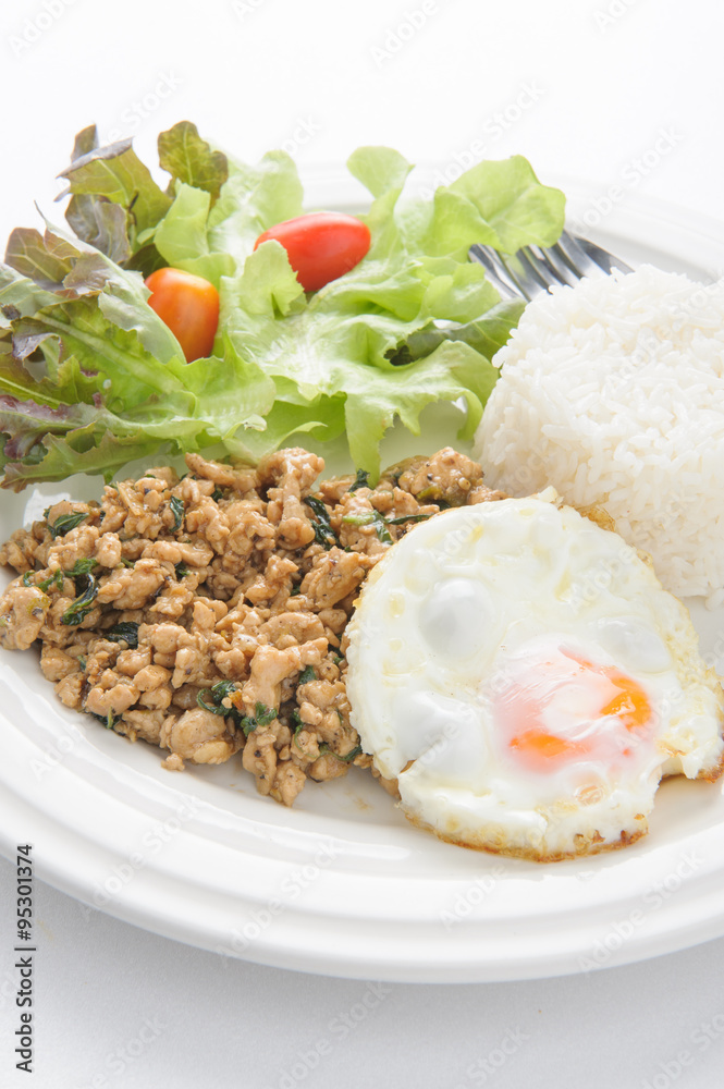 Thai spicy food basil pork with rice and fried egg on top (Krapa