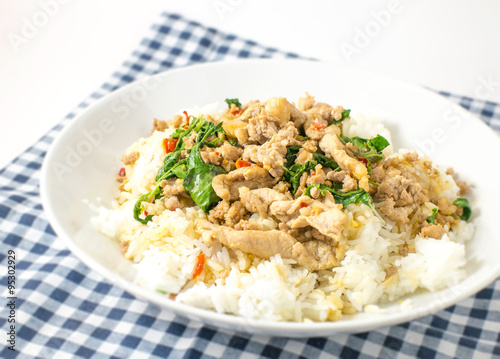 stir fried pork basil and rice on blue tablecloth