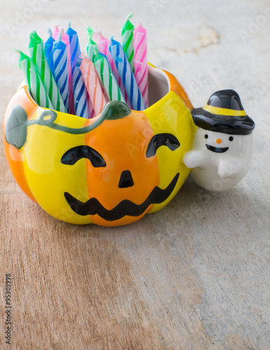 pumpkin cup and colorful candle for happy halloween
