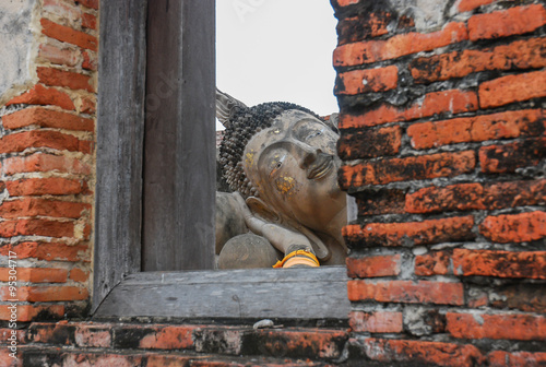 Ruin and ancient orange brick wall with a window view to the tre photo