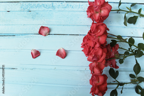 Foral background - red roses on vintage wooden background photo