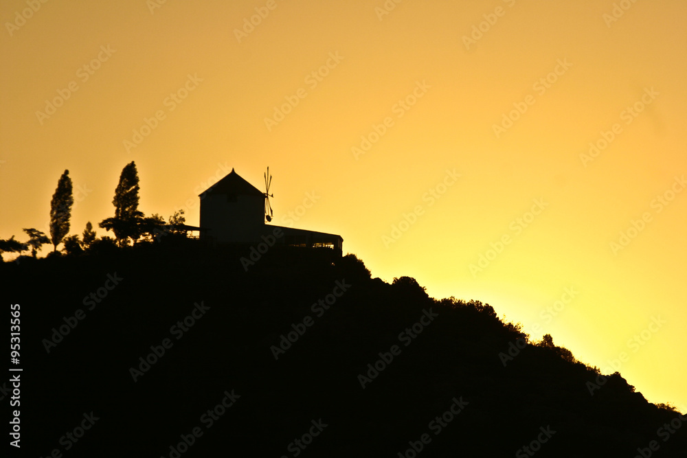 Silhouette of a wind mill in the sunset in Peloponese in greece