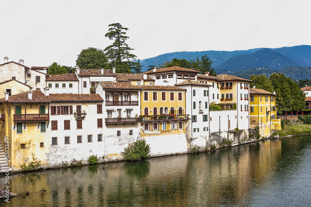 facade of houses at river brenta with village Basano del Grappa