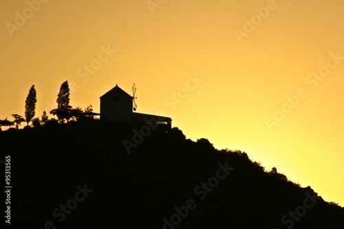 Silhouette of a wind mill in the sunset in Peloponese in greece