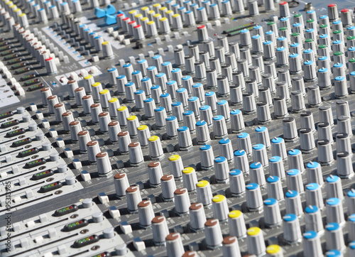 Giant audio sound mixer with color buttons and sliders