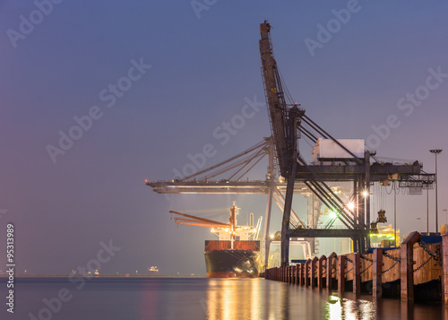 Containers loading by crane on morning dark
