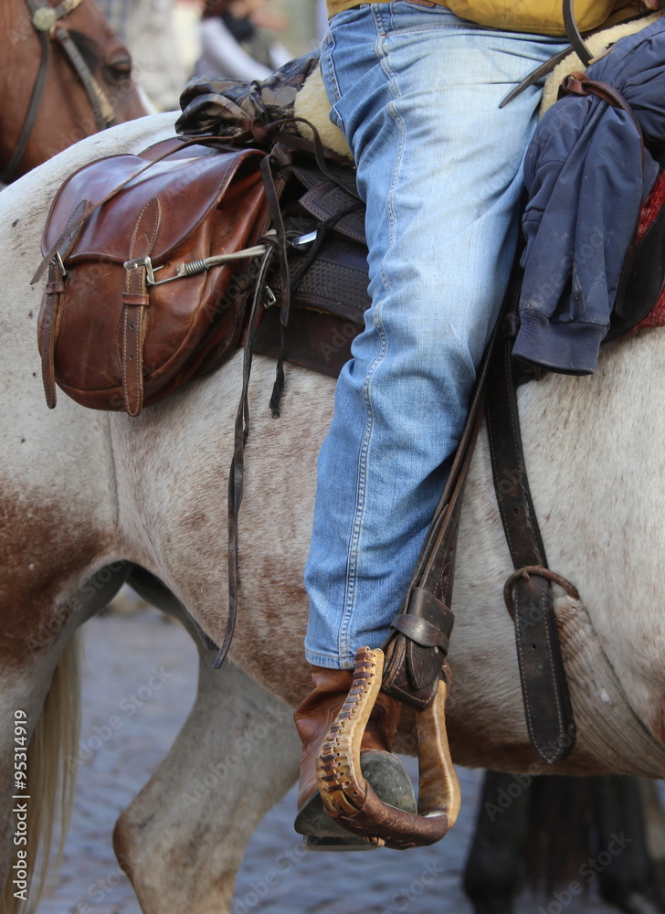 Cowboy foot in the stirrup of the horse - obrazy, fototapety, plakaty 