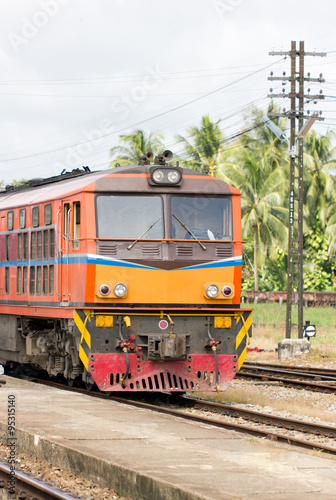 Vintage train on track at station, Thailand.