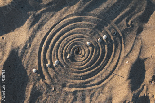 Conceptual sundial on the beach sand