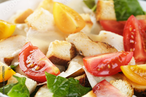caesar salad with chiken fillet and different color tomatoes