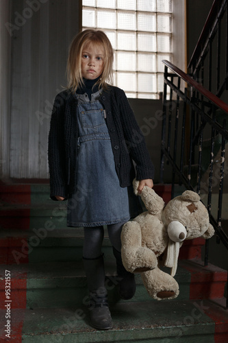 Miserable girl standing on the staircase