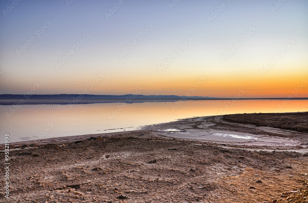 Beautiful sunrise on salt lake Chott el Djerid, Sahara desert, T