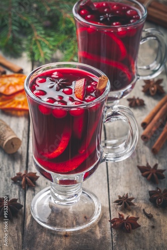 Homemade mulled wine with orange slices, cranberries, cinnamon and anise