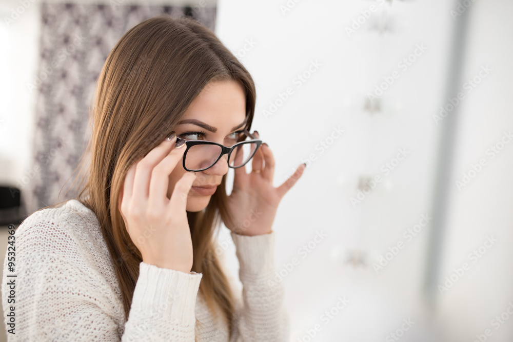 Woman try on glasses for good vision Woman try on glasses for good vision