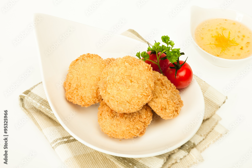 Fried coated cutlets with cherry tomatoes in a bowl