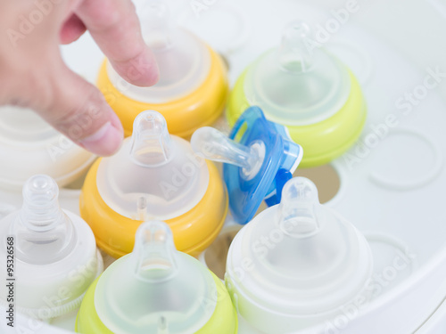 Wallpaper Mural Hand reach out to pick nipple up in nipple steam sterilizer. Torontodigital.ca