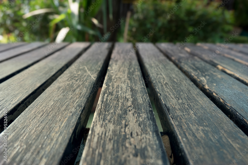 old table wood plank with green natural blurred background