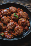 Close-up of a frying pan with meatballs in tomato sauce