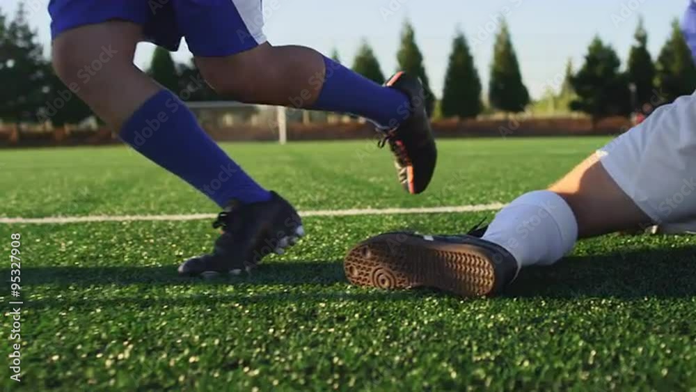 A soccer player does some fancy footwork and opponents slide tackle him
A soccer player does some fancy footwork and opponents slide tackle him