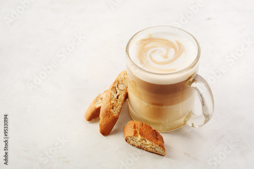 Cappuccino with biscotti or cantucci on a white table