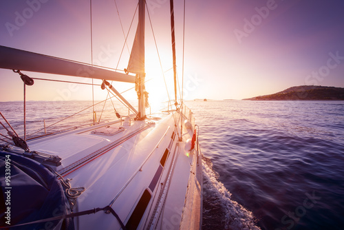 Fototapeta Naklejka Na Ścianę i Meble -  amazing view to yacht sailing at sunset