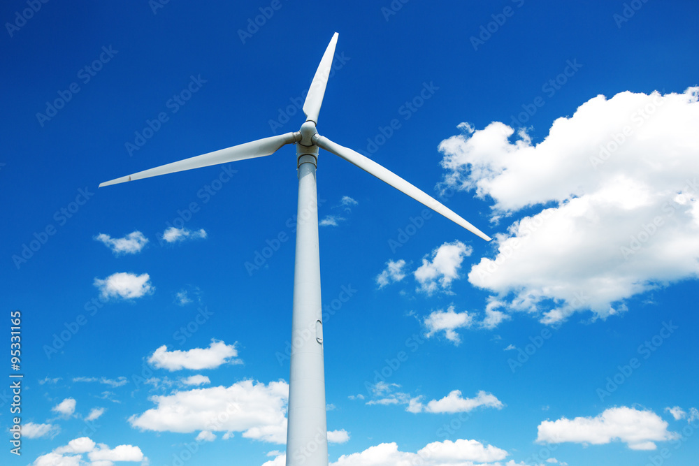 Wind generator turbine against deep blue sky with clouds Wind generator turbine against deep blue sky with clouds
