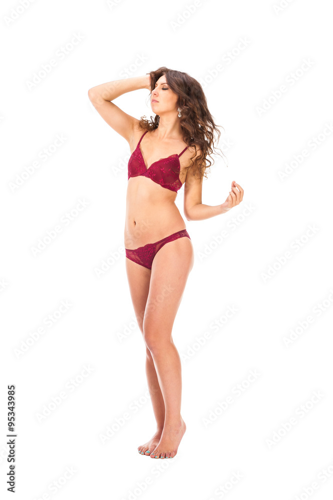 Young slim brunette girl posing in a studio in lacy underwear Young slim brunette girl posing in a studio in lacy underwear