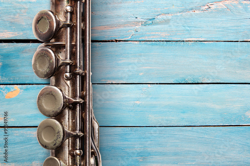 Photography Old flute on blue wooden boards