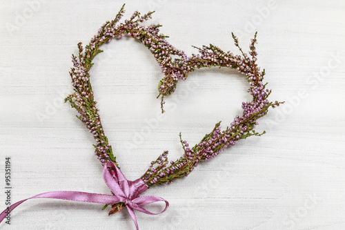 Florist at work: steps of making heather (erica) door wreath
