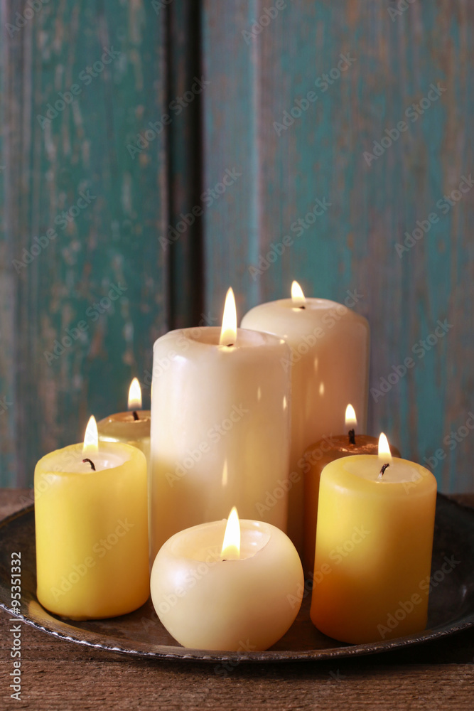 Golden candles on wooden table Golden candles on wooden table