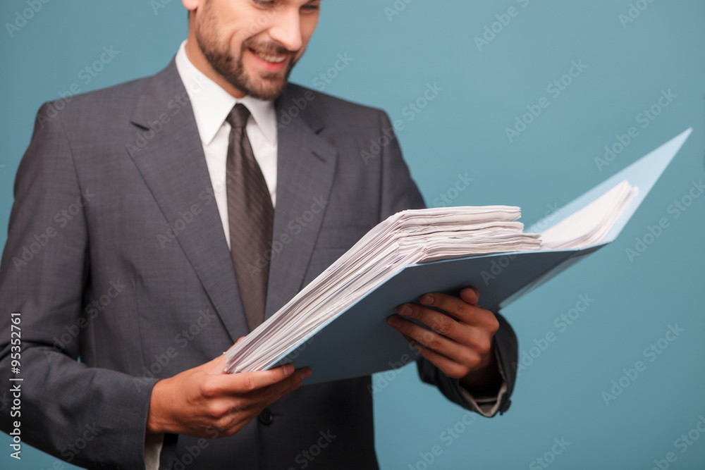 Professional young businessman is working with papers