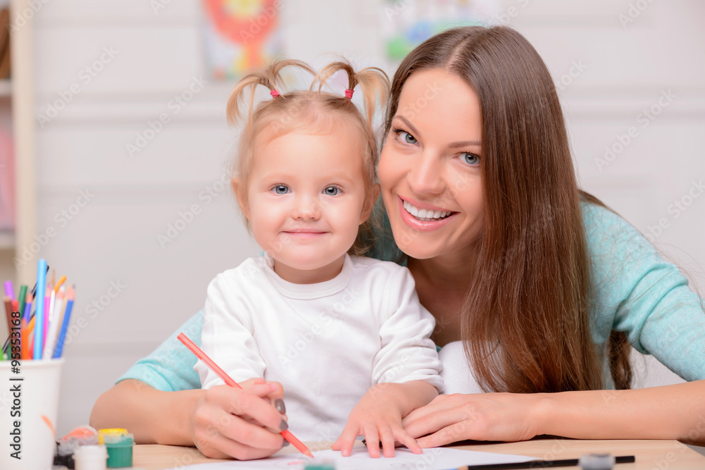 Pretty young woman is spending time with her child Pretty young woman is spending time with her child