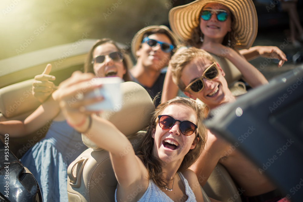 Obraz premium young people having fun and taking selfies with a smartphone