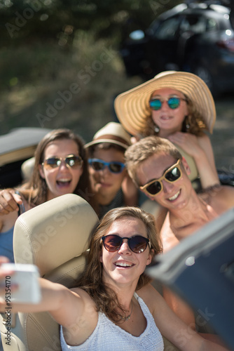 young people having fun and taking selfies with a smartphone