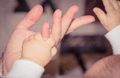 newborn baby hand playing with adult finger  maternity concept