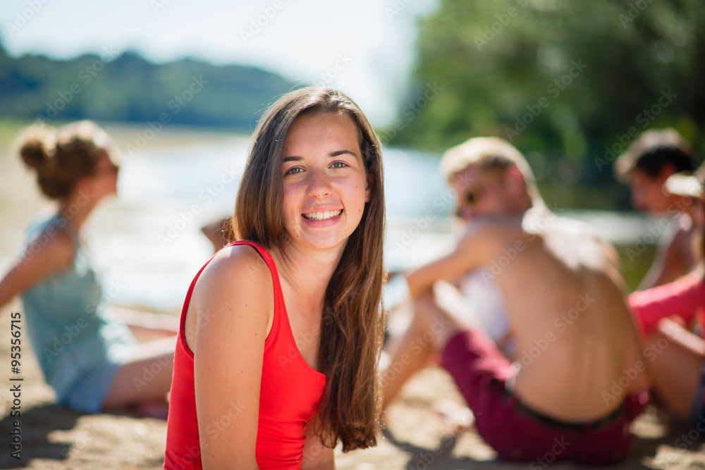 Focus on a beautiful young girl hanging out with their friends Focus on a beautiful young girl hanging out with their friends