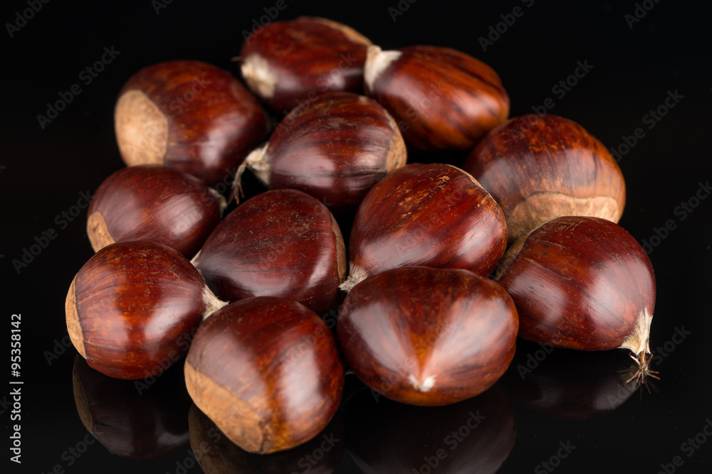 Chestnuts on a black reflective background Chestnuts on a black reflective background